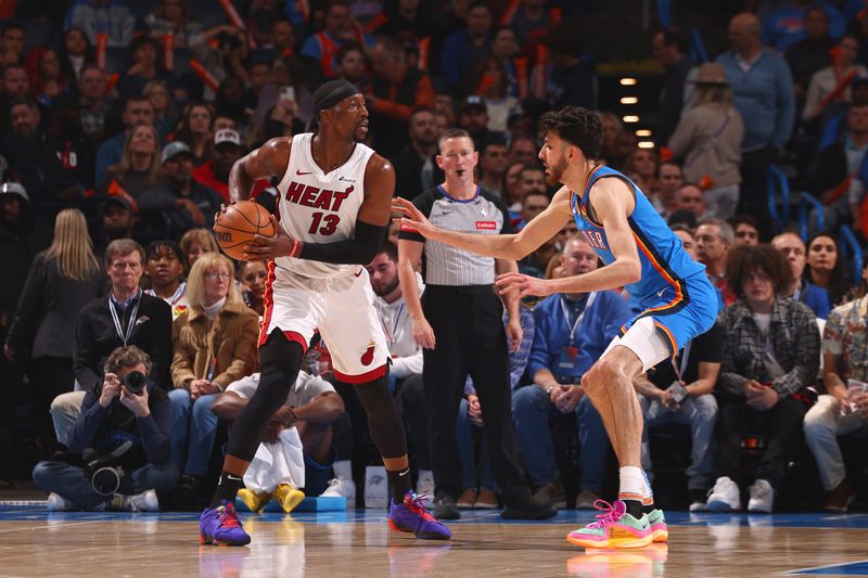 OKLAHOMA CITY, OK - MARCH 8:  Bam Adebayo #13 of the Miami Heat handles the ball during the game as Chet Holmgren #7 of the Oklahoma City Thunder plays defense on March 8, 2024 at Paycom Arena in Oklahoma City, Oklahoma. NOTE TO USER: User expressly acknowledges and agrees that, by downloading and or using this photograph, User is consenting to the terms and conditions of the Getty Images License Agreement. Mandatory Copyright Notice: Copyright 2024 NBAE (Photo by Zach Beeker/NBAE via Getty Images)