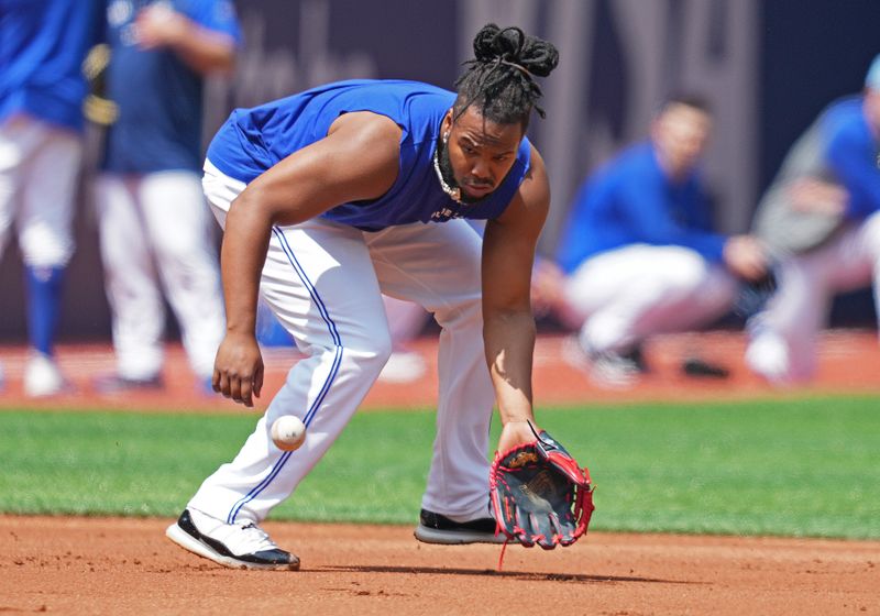 May 20, 2024; Toronto, Ontario, CAN; Toronto Blue Jays first base Vladimir Guerrero Jr. (27) fields balls during batting practice before a game against the Chicago White Sox at Rogers Centre. Mandatory Credit: Nick Turchiaro-USA TODAY Sports