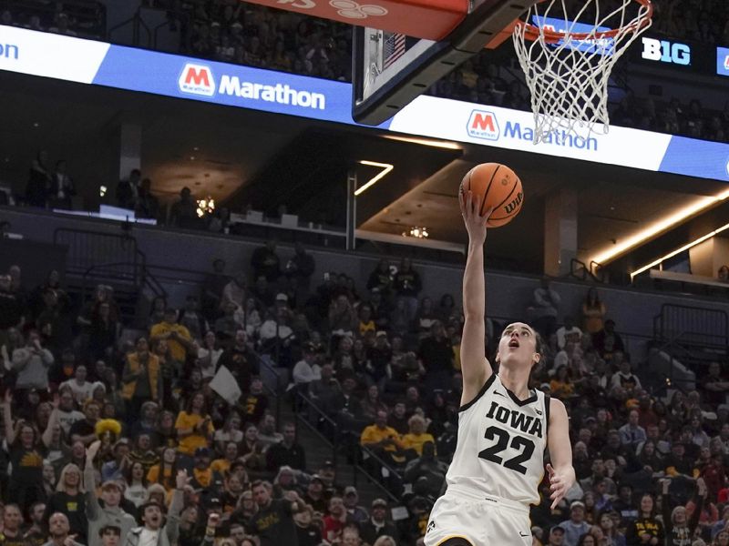 Mar 9, 2024; Minneapolis, MN, USA;  Iowa Hawkeyes guard Caitlin Clark (22) lays the ball in against the Michigan Wolverines during the second half of a Big Ten Women's Basketball tournament semifinal at Target Center. Mandatory Credit: Nick Wosika-USA TODAY Sports