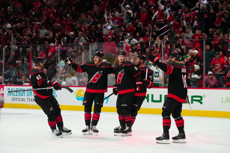 Apr 5, 2024; Raleigh, North Carolina, USA; Carolina Hurricanes center Martin Necas (88) celebrates his goal with center Evgeny Kuznetsov (92) defenseman Brady Skjei (76) right wing Stefan Noesen (23) and center Jack Drury (18) against the Washington Capitals during the third period at PNC Arena. Mandatory Credit: James Guillory-USA TODAY Sports