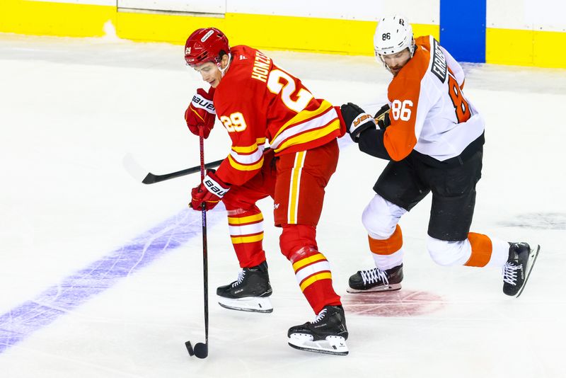 Oct 12, 2024; Calgary, Alberta, CAN; Calgary Flames left wing Samuel Honzek (29) and Philadelphia Flyers left wing Joel Farabee (86) battles for the puck during the first period at Scotiabank Saddledome. Mandatory Credit: Sergei Belski-Imagn Images