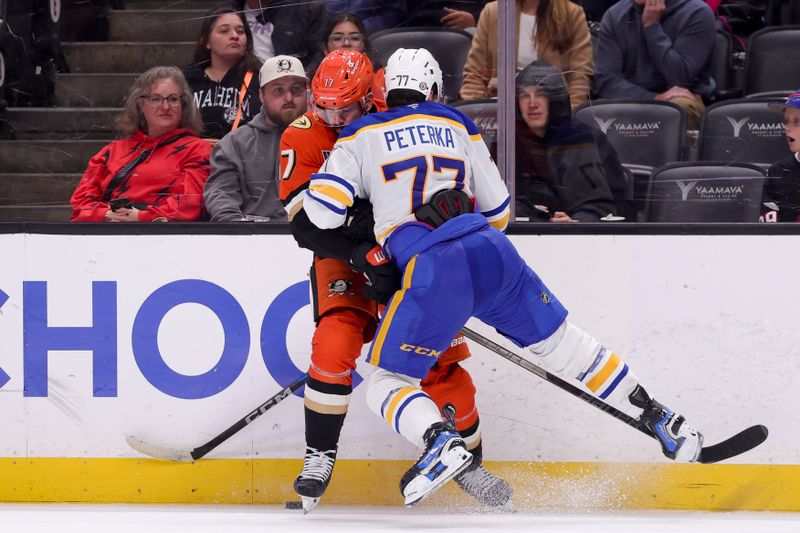 Nov 22, 2024; Anaheim, California, USA; Buffalo Sabres right wing JJ Peterka (77) collides with Anaheim Ducks left wing Alex Killorn (17) during overtime at Honda Center. Mandatory Credit: Ryan Sun-Imagn Images