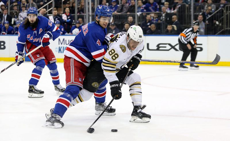 Nov 25, 2023; New York, New York, USA; Boston Bruins right wing David Pastrnak (88) tries to take a shot while New York Rangers defenseman Braden Schneider (4) defends during the third period at Madison Square Garden. Mandatory Credit: Danny Wild-USA TODAY Sports