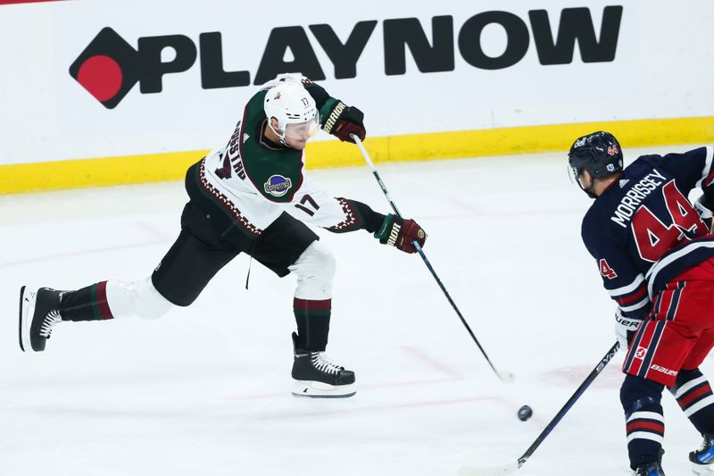 Nov 18, 2023; Winnipeg, Manitoba, CAN;  Arizona Coyotes forward Nick Bjugstad (17) takes a shot on the Winnipeg Jets net during the third period at Canada Life Centre. Mandatory Credit: Terrence Lee-USA TODAY Sports