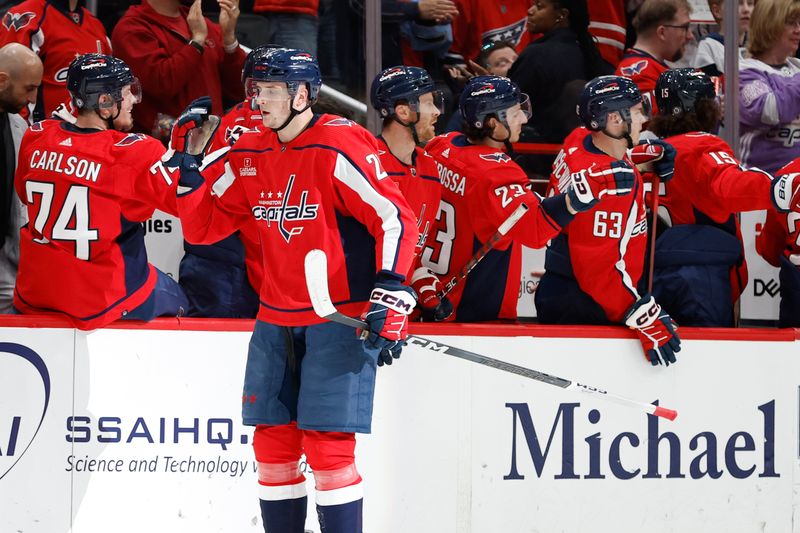 Apr 7, 2024; Washington, District of Columbia, USA; Washington Capitals center Aliaksei Protas (21) celebrates with teammates after scoring a goal against the Ottawa Senators in the second period at Capital One Arena. Mandatory Credit: Geoff Burke-USA TODAY Sports