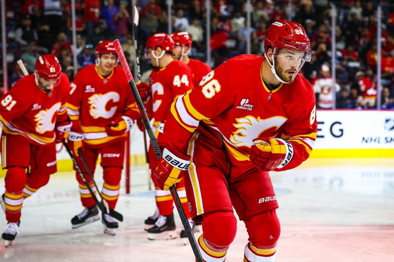 Oct 1, 2025; Calgary, Alberta, CAN; Calgary Flames left wing Joel Farabee (86) celebrates his goal with teammates against the Vancouver Canucks during the second period at Scotiabank Saddledome. Mandatory Credit: Sergei Belski-Imagn Images