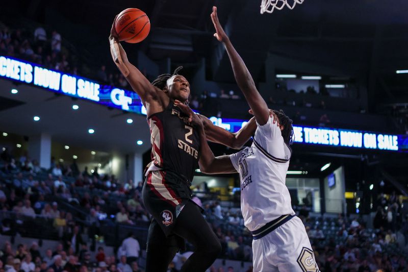 Mar 2, 2024; Atlanta, Georgia, USA; Florida State Seminoles forward Jamir Watkins (2) dunks over Georgia Tech Yellow Jackets forward Baye Ndongo (11) in the first half at McCamish Pavilion. Mandatory Credit: Brett Davis-USA TODAY Sports
