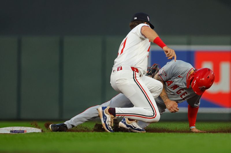Sep 11, 2024; Minneapolis, Minnesota, USA; Minnesota Twins second baseman Edouard Julien (47) tags out Los Angeles Angels center fielder Mickey Moniak (16) on an attempted steal in the fifth inning at Target Field. Mandatory Credit: Bruce Kluckhohn-Imagn Images