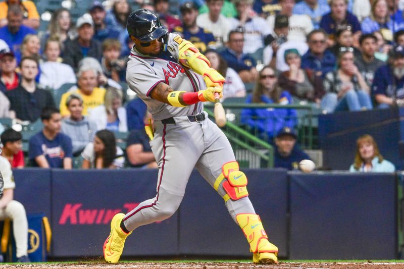 Jun 10, 2025; Milwaukee, Wisconsin, USA; Atlanta Braves right fielder Ronald Acuna (13) drives in a run with a base hit against the Milwaukee Brewers in the fifth inning at American Family Field. Mandatory Credit: Benny Sieu-Imagn Images