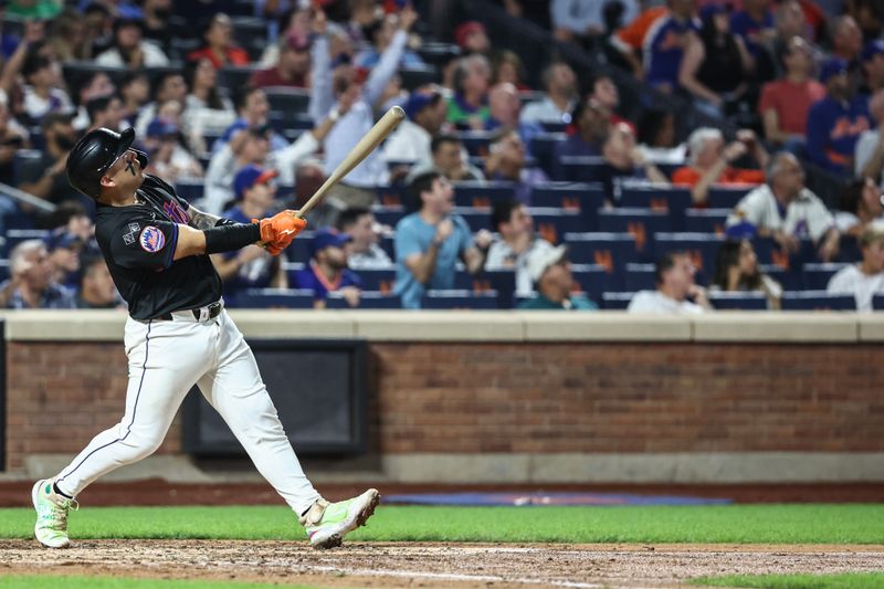 Sep 19, 2024; New York City, New York, USA;  New York Mets catcher Francisco Alvarez (4) hits a three run home run in the fourth inning against the Philadelphia Phillies at Citi Field. Mandatory Credit: Wendell Cruz-Imagn Images