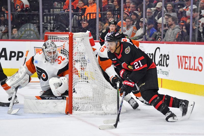 Mar 2, 2024; Philadelphia, Pennsylvania, USA; Ottawa Senators right wing Mathieu Joseph (21) carries the puck against Philadelphia Flyers defenseman Travis Sanheim (6) and goaltender Felix Sandstrom (32) during the second period at Wells Fargo Center. Mandatory Credit: Eric Hartline-USA TODAY Sports