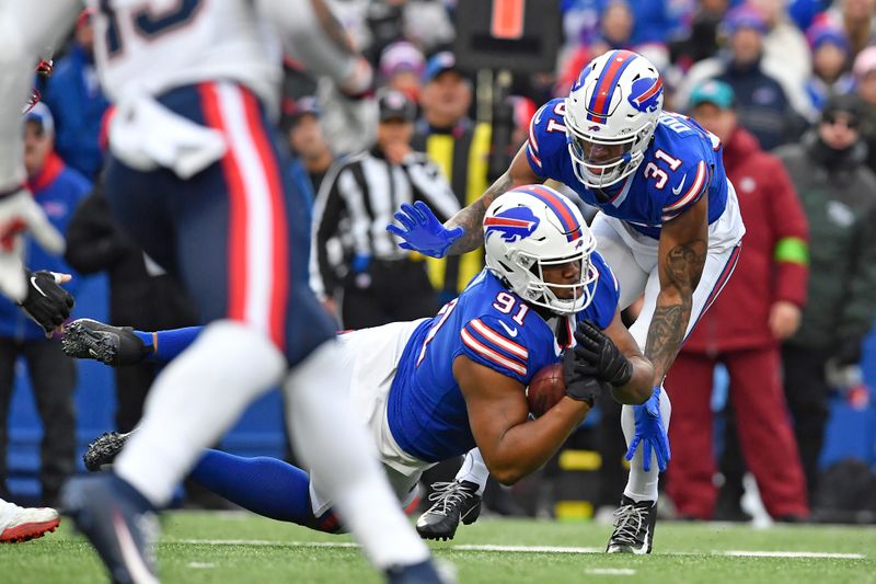 Buffalo Bills defensive tackle Ed Oliver (91) intercepts a pass by New England Patriots quarterback Bailey Zappe (4) during the first half of an NFL football game in Orchard Park, N.Y., Sunday, Dec. 31, 2023. (AP Photo/Adrian Kraus)