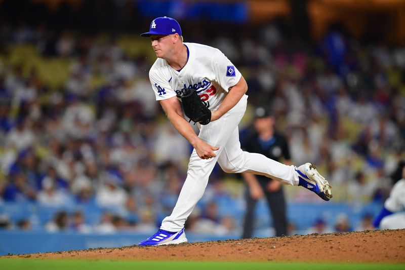 Aug 19, 2024; Los Angeles, California, USA; Los Angeles Dodgers pitcher Evan Phillips (59) throws against the Seattle Mariners during the ninth inning at Dodger Stadium. Mandatory Credit: Gary A. Vasquez-USA TODAY Sports