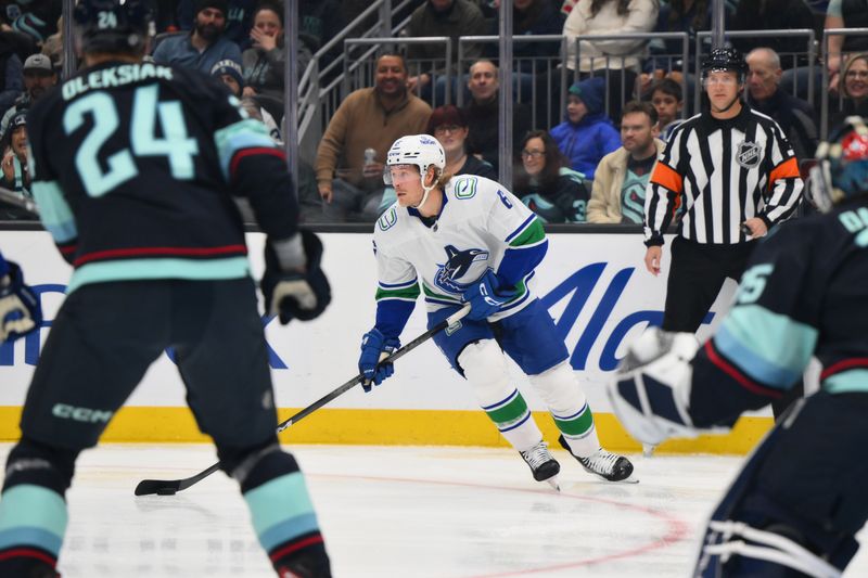 Nov 24, 2023; Seattle, Washington, USA; Vancouver Canucks right wing Brock Boeser (6) plays the puck during the first period against the Seattle Kraken at Climate Pledge Arena. Mandatory Credit: Steven Bisig-USA TODAY Sports