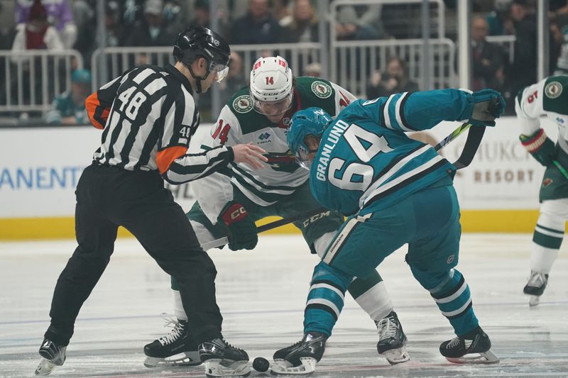 Apr 13, 2024; San Jose, California, USA; Minnesota Wild center Joel Eriksson Ek (14) and San Jose Sharks center Mikael Granlund (64) face off during the first period at SAP Center at San Jose. Mandatory Credit: David Gonzales-USA TODAY Sports