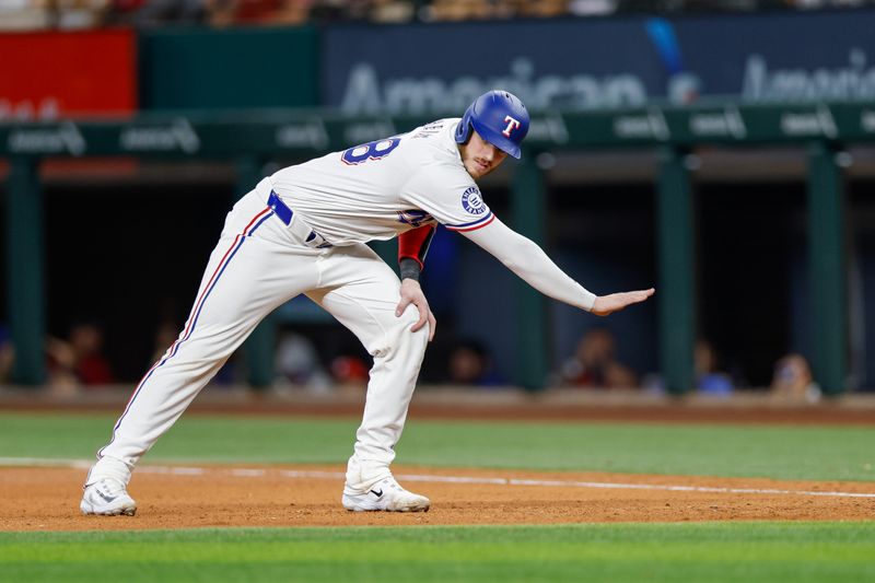 Jul 23, 2024; Arlington, Texas, USA; Texas Rangers catcher Jonah Heim (28) takes a lead at first base during the seventh inning against the Chicago White Sox at Globe Life Field. Mandatory Credit: Andrew Dieb-USA TODAY Sports