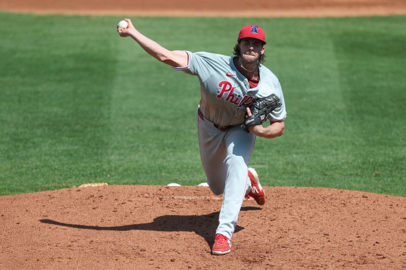 Mar 7, 2024; Port Charlotte, Florida, USA;  Philadelphia Phillies starting pitcher Aaron Nola (27) throws a pitch against the Tampa Bay Rays in the third inning at Charlotte Sports Park. Mandatory Credit: Nathan Ray Seebeck-USA TODAY Sports