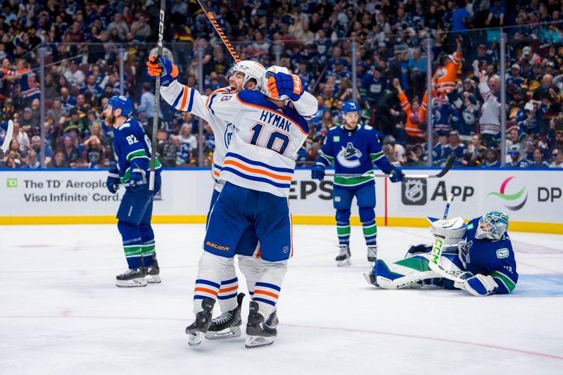 May 10, 2024; Vancouver, British Columbia, CAN; Vancouver Canucks defenseman Ian Cole (82) and goalie Arturs Silvos (31) react as Edmonton Oilers defenseman Evan Bouchard (2) and forward Zach Hyman (18) celebrate Bouchard’s game winning goal against the Vancouver Canucks during the first overtime in game two of the second round of the 2024 Stanley Cup Playoffs at Rogers Arena. Mandatory Credit: Bob Frid-USA TODAY Sports