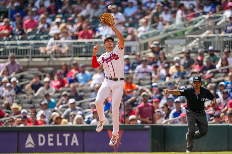 Sep 20, 2023; Cumberland, Georgia, USA; Atlanta Braves first baseman Matt Olson (28) plays a ball that hit the first base bag during the game against the Philadelphia Phillies during the eighth inning at Truist Park. Mandatory Credit: Dale Zanine-USA TODAY Sports