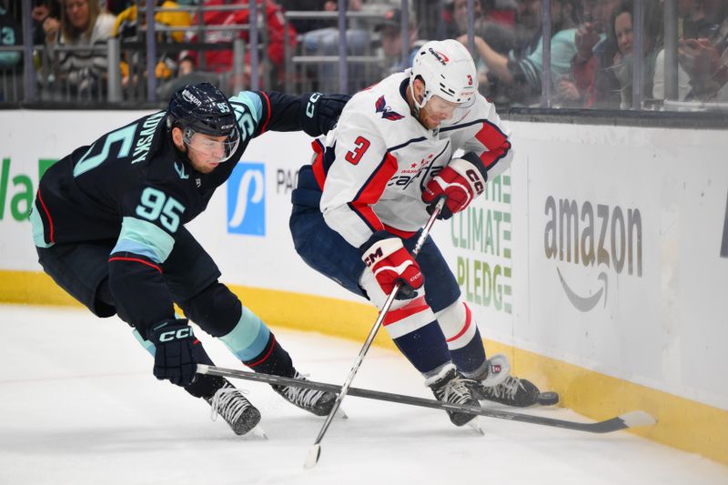 Mar 14, 2024; Seattle, Washington, USA; Seattle Kraken left wing Andre Burakovsky (95) and Washington Capitals defenseman Nick Jensen (3) play the puck against the wall during the second period at Climate Pledge Arena. Mandatory Credit: Steven Bisig-USA TODAY Sports