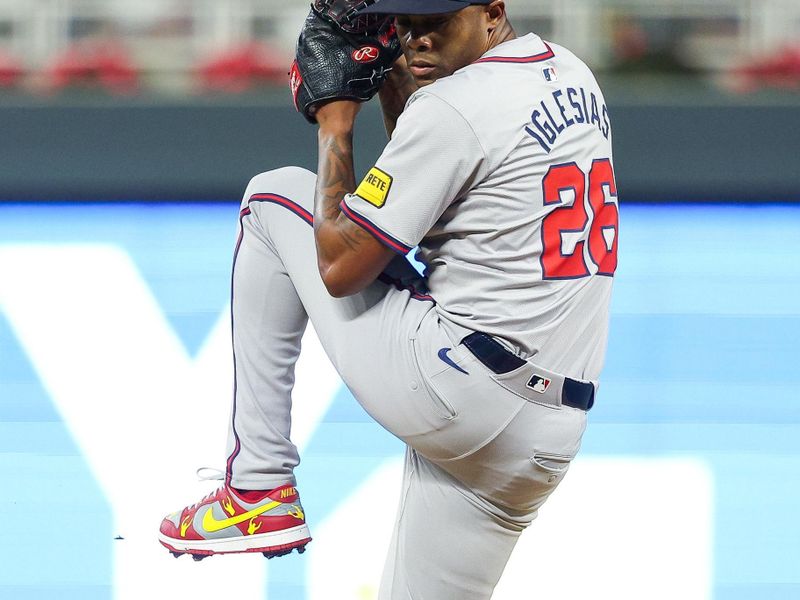 Aug 28, 2024; Minneapolis, Minnesota, USA; Atlanta Braves relief pitcher Raisel Iglesias (26) delivers a pitch against Minnesota Twins during the ninth inning at Target Field. Mandatory Credit: Matt Krohn-USA TODAY Sports