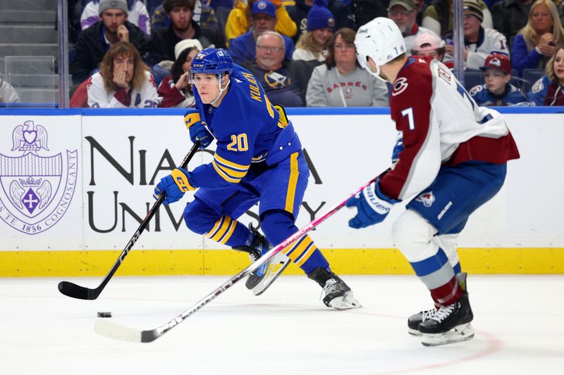 Dec 3, 2024; Buffalo, New York, USA;  Buffalo Sabres center Jiri Kulich (20) skates with the puck as Colorado Avalanche defenseman Devon Toews (7) defends during the second period at KeyBank Center. Mandatory Credit: Timothy T. Ludwig-Imagn Images