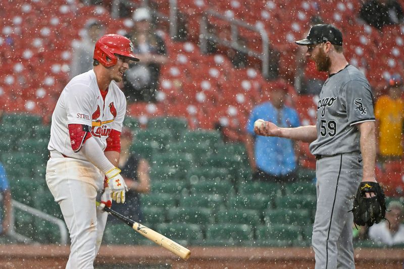 May 4, 2024; St. Louis, Missouri, USA;  Chicago White Sox relief pitcher John Brebbia (59) talks with St. Louis Cardinals second baseman Nolan Gorman (16) as heavy rain falls during the tenth inning at Busch Stadium. Mandatory Credit: Jeff Curry-USA TODAY Sports