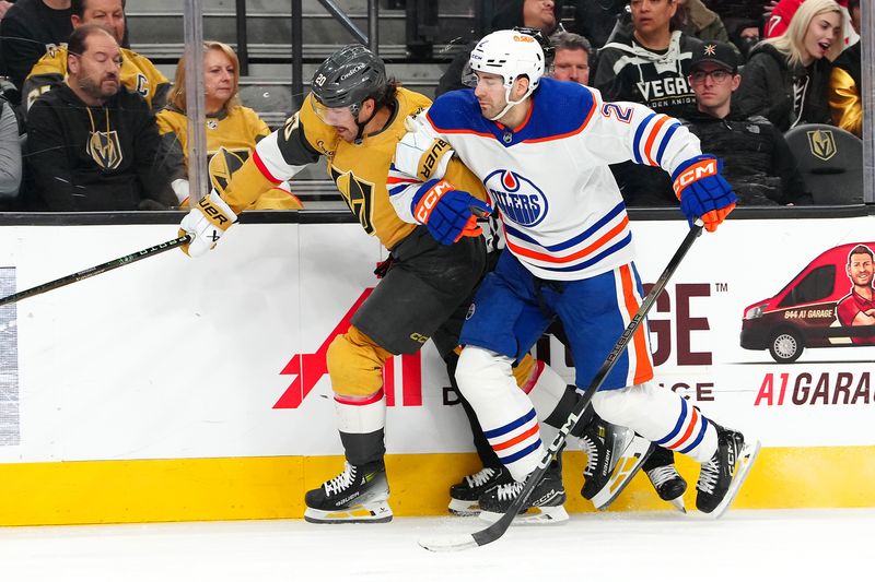 Feb 6, 2024; Las Vegas, Nevada, USA; Edmonton Oilers defenseman Evan Bouchard (2) slows down Vegas Golden Knights center Chandler Stephenson (20) during the third period at T-Mobile Arena. Mandatory Credit: Stephen R. Sylvanie-USA TODAY Sports