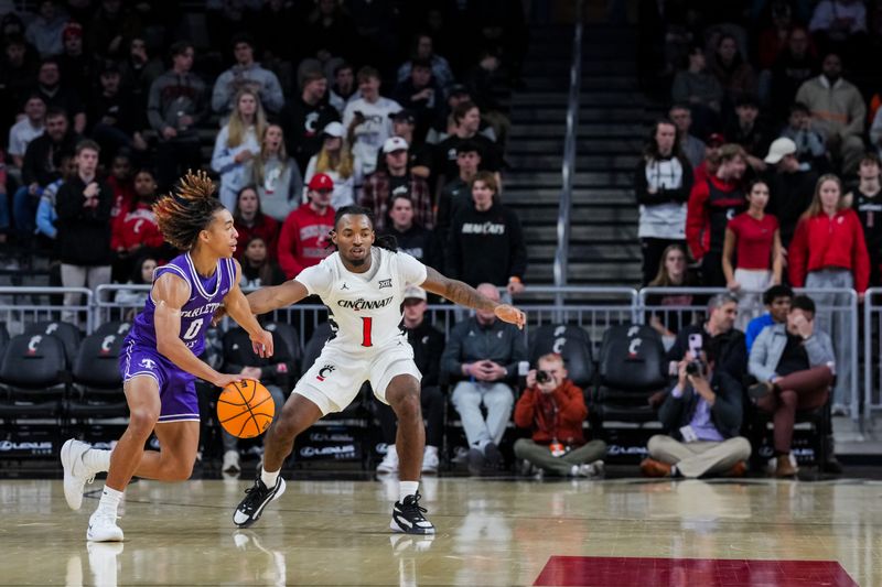 Dec 1, 2025; Cincinnati, Ohio, USA;  Tarleton State Texans guard Jordan Mizell (0) dribbles the ball against Cincinnati Bearcats guard Day Day Thomas (1) in the first half at Fifth Third Arena. Mandatory Credit: Aaron Doster-Imagn Images