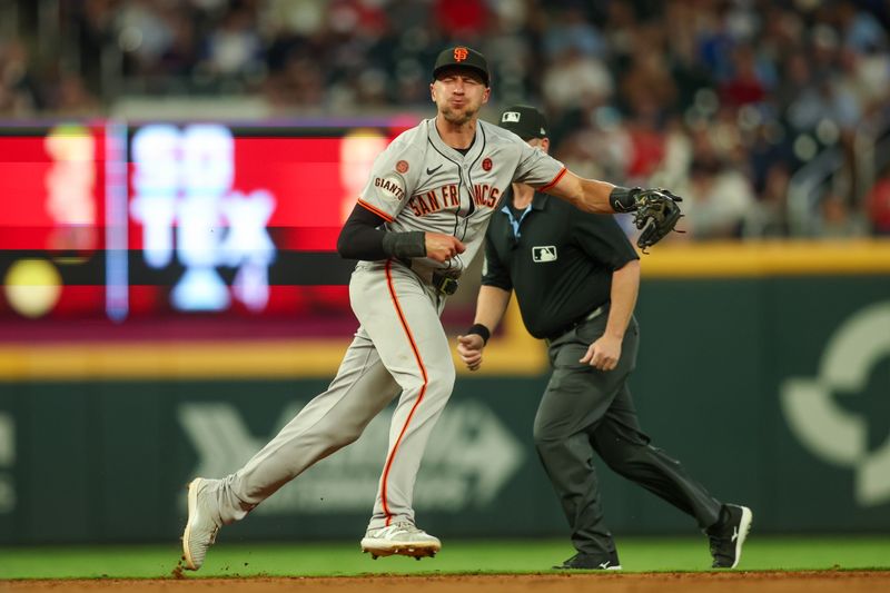 Jul 2, 2024; Atlanta, Georgia, USA; San Francisco Giants shortstop Nick Ahmed (16) throws a runner out at first against the Atlanta Braves in the sixth inning at Truist Park. Mandatory Credit: Brett Davis-USA TODAY Sports