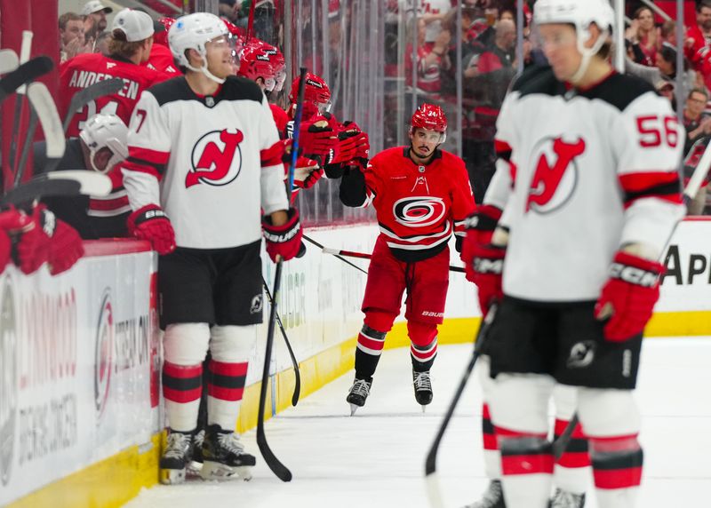 Oct 15, 2024; Raleigh, North Carolina, USA;  Carolina Hurricanes center Seth Jarvis (24) celebrates his goal against the New Jersey Devils during the second period at PNC Arena. Mandatory Credit: James Guillory-Imagn Images