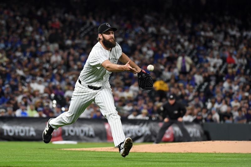 Jun 25, 2025; Denver, Colorado, USA; Colorado Rockies pitcher Jake Bird (59) tosses the ball to first for an out during the sixth inning against the Los Angeles Dodgers at Coors Field. Mandatory Credit: Christopher Hanewinckel-Imagn Images