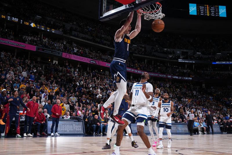 DENVER, CO - APRIL 10: Christian Braun #0 of the Denver Nuggets dunks the ball during the game against the Minnesota Timberwolves  on April 10, 2024 at the Ball Arena in Denver, Colorado. NOTE TO USER: User expressly acknowledges and agrees that, by downloading and/or using this Photograph, user is consenting to the terms and conditions of the Getty Images License Agreement. Mandatory Copyright Notice: Copyright 2024 NBAE (Photo by Garrett Ellwood/NBAE via Getty Images)