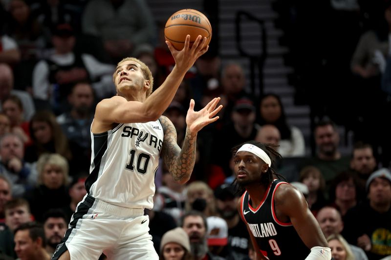 PORTLAND, OREGON - DECEMBER 28: Jeremy Sochan #10 of the San Antonio Spurs shoots against Jerami Grant #9 of the Portland Trail Blazers during the second quarter at Moda Center on December 28, 2023 in Portland, Oregon. NOTE TO USER: User expressly acknowledges and agrees that, by downloading and or using this photograph, User is consenting to the terms and conditions of the Getty Images License Agreement. (Photo by Steph Chambers/Getty Images)