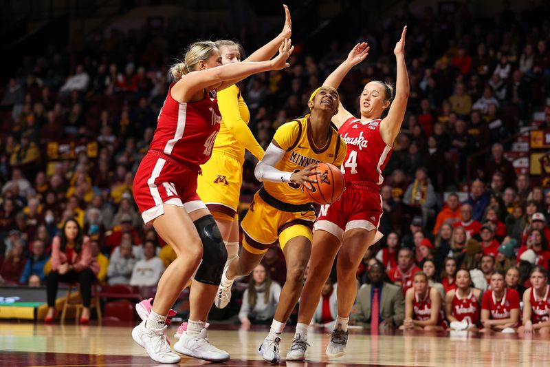 Jan 14, 2024; Minneapolis, Minnesota, USA; Minnesota Golden Gophers guard Janay Sanders (30) drives to the basket as Nebraska Cornhuskers center Alexis Markowski (40) and guard Callin Hake (14) defend during the first half at Williams Arena. Mandatory Credit: Matt Krohn-USA TODAY Sports