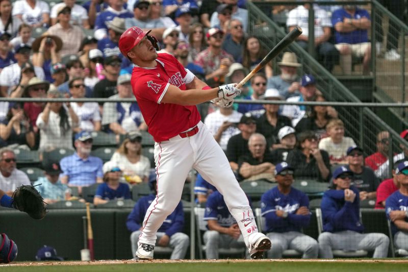 Mar 5, 2025; Tempe, Arizona, USA; Los Angeles Angels outfielder Mike Trout (27) hits a home run against the Los Angeles Dodgers in the first inning at Tempe Diablo Stadium. Mandatory Credit: Rick Scuteri-Imagn Images