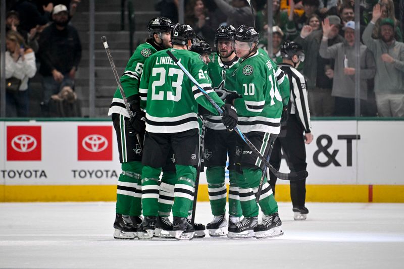 Jan 31, 2025; Dallas, Texas, USA; Dallas Stars defenseman Lian Bichsel (6) and defenseman Esa Lindell (23) and center Oskar Back (10) celebrates a goal scored by Back against the Vancouver Canucks during the first period at the American Airlines Center. Mandatory Credit: Jerome Miron-Imagn Images