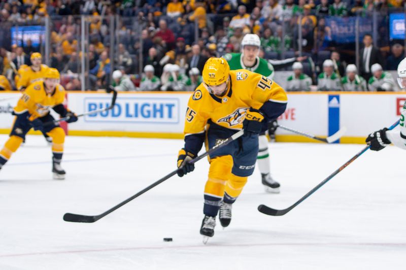 Feb 15, 2024; Nashville, Tennessee, USA; Nashville Predators defenseman Alexandre Carrier (45) skates with the puck  against the Dallas Stars during the first period at Bridgestone Arena. Mandatory Credit: Steve Roberts-USA TODAY Sports