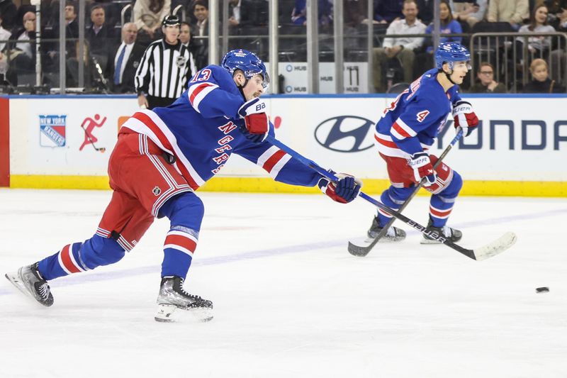 Jan 28, 2025; New York, New York, USA; New York Rangers left wing Alexis Lafrenière (13) attempts a shot on goal in the third period against the Carolina Hurricanes at Madison Square Garden. Mandatory Credit: Wendell Cruz-Imagn Images