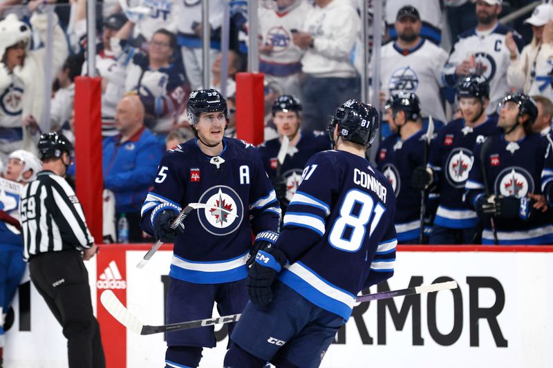 Apr 21, 2024; Winnipeg, Manitoba, CAN; Winnipeg Jets center Mark Scheifele (55) celebrates his first period goal with Winnipeg Jets left wing Kyle Connor (81)  against the Colorado Avalanche in game one of the first round of the 2024 Stanley Cup Playoffs at Canada Life Centre. Mandatory Credit: James Carey Lauder-USA TODAY Sports