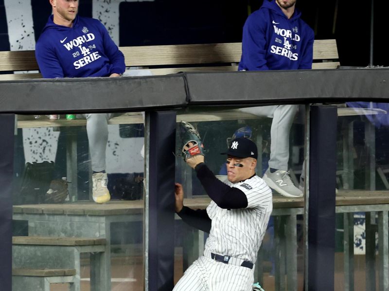 Oct 30, 2024; New York, New York, USA; New York Yankees outfielder Aaron Judge (99) makes a catch during the fourth inning against the Los Angeles Dodgers in game five of the 2024 MLB World Series at Yankee Stadium. Mandatory Credit: Wendell Cruz-Imagn Images