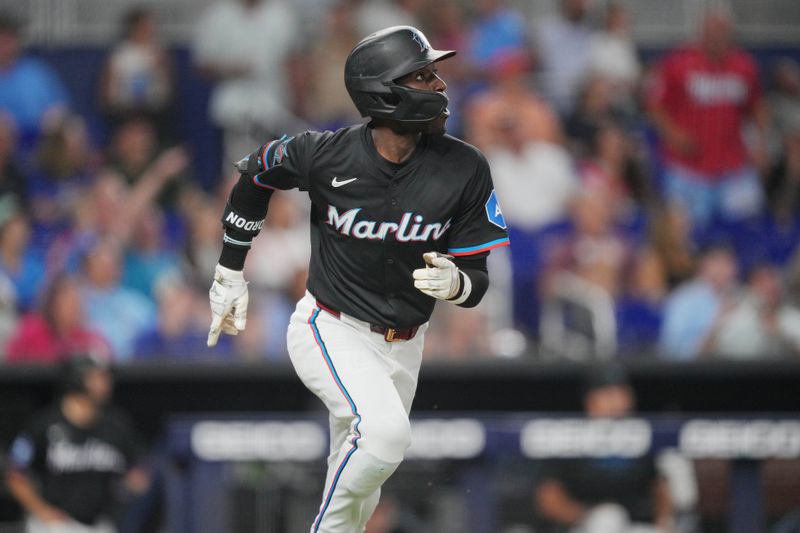 May 31, 2024; Miami, Florida, USA;  Miami Marlins left fielder Nick Gordon (1) watches his two-run home run against the Texas Rangers in the second inning at loanDepot Park. Mandatory Credit: Jim Rassol-USA TODAY Sports