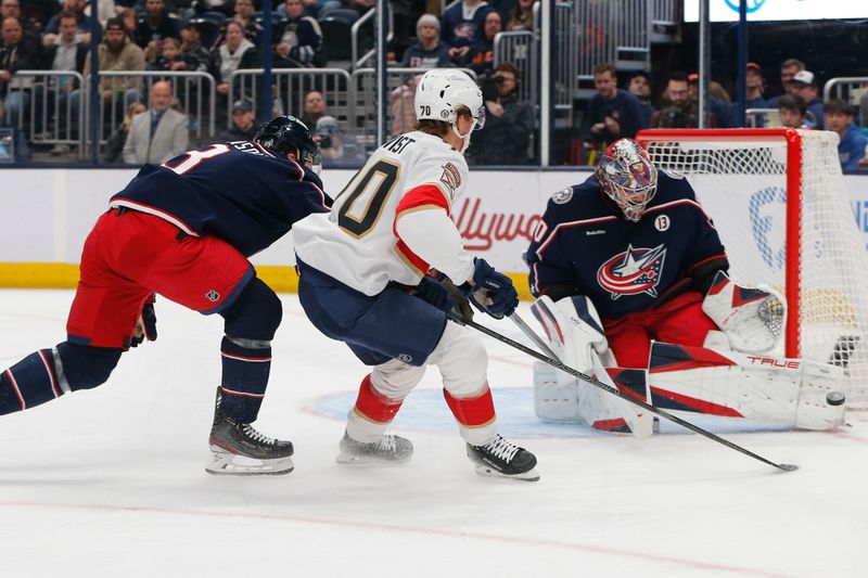 Mar 20, 2025; Columbus, Ohio, USA; Columbus Blue Jackets goalie Elvis Merzlikins (90) makes a save on the shot from Florida Panthers left wing A.J. Greer (10) during the first period at Nationwide Arena. Mandatory Credit: Russell LaBounty-Imagn Images