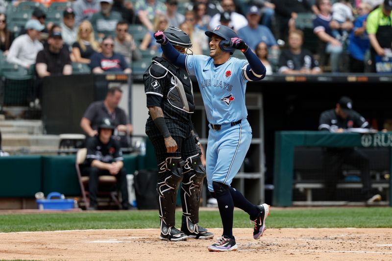 May 27, 2024; Chicago, Illinois, USA; Toronto Blue Jays outfielder George Springer (4) crosses home plate after hitting a two-run home run against the Chicago White Sox during the second inning at Guaranteed Rate Field. Mandatory Credit: Kamil Krzaczynski-USA TODAY Sports