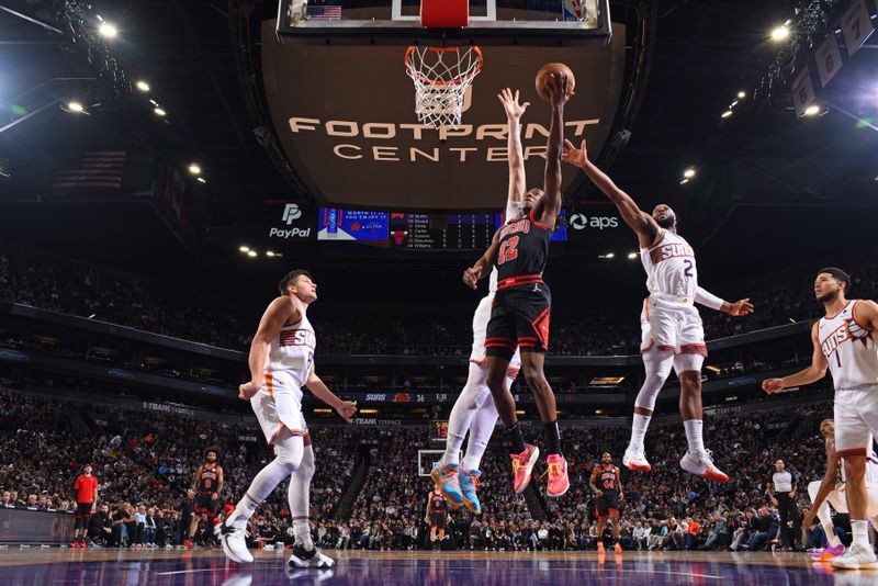 PHOENIX, AZ - JANUARY 22: Ayo Dosunmu #12 of the Chicago Bulls drives to the basket during the game against the Phoenix Suns on January 22, 2024 at Footprint Center in Phoenix, Arizona. NOTE TO USER: User expressly acknowledges and agrees that, by downloading and or using this photograph, user is consenting to the terms and conditions of the Getty Images License Agreement. Mandatory Copyright Notice: Copyright 2024 NBAE (Photo by Garrett Ellwood/NBAE via Getty Images)