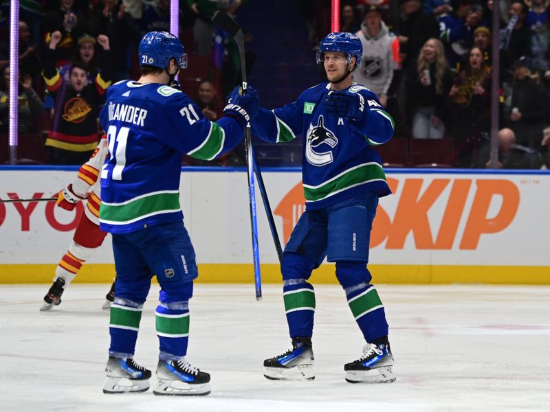 Mar 23, 2024; Vancouver, British Columbia, CAN; Vancouver Canucks forward Nils Hoglander (21) celebrates a goal with Vancouver Canucks forward Elias  Pettersson (40) against Calgary Flames during the first period at Rogers Arena. Mandatory Credit: Simon Fearn-USA TODAY Sports