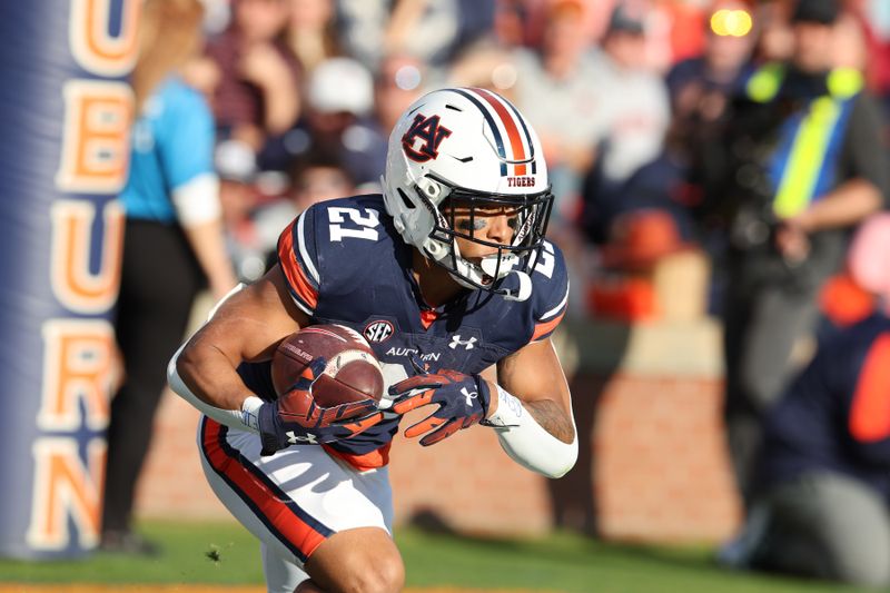 Nov 25, 2023; Auburn, Alabama, USA;  Auburn Tigers running back Brian Battie (21) returns a kick during the first quarter against the Alabama Crimson Tide at Jordan-Hare Stadium. Mandatory Credit: John Reed-USA TODAY Sports