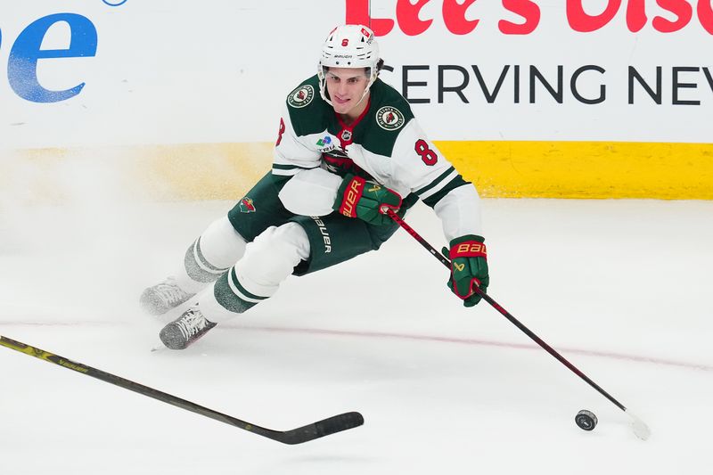 Apr 20, 2025; Las Vegas, Nevada, USA; Minnesota Wild defenseman Zeev Buium (8) skates against the Vegas Golden Knights during the third period of game one of the first round of the 2025 Stanley Cup Playoffs at T-Mobile Arena. Mandatory Credit: Stephen R. Sylvanie-Imagn Images