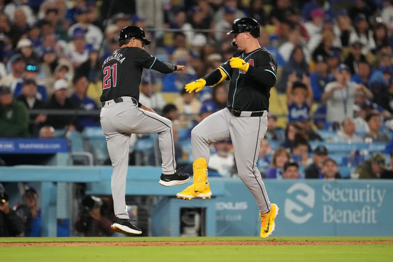 May 21, 2024; Los Angeles, California, USA; Arizona Diamondbacks designated hitter Joc Pederson (3) celebrates with third base coach Tony Perezchica (21) after hitting a three-run home run in the seventh inning against the Los Angeles Dodgers at Dodger Stadium. Mandatory Credit: Kirby Lee-USA TODAY Sports