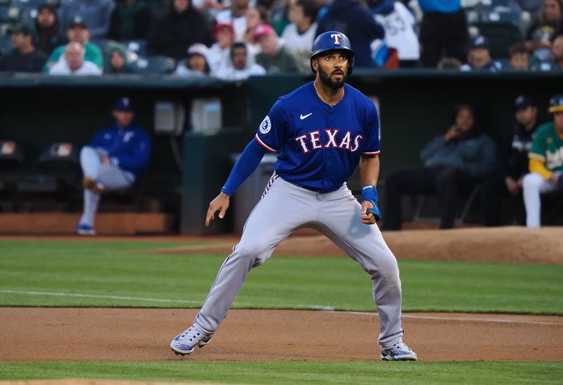 Sep 25, 2024; Oakland, California, USA; Texas Rangers second baseman Marcus Semien (2) takes a lead off first base against the Oakland Athletics during the first inning at Oakland-Alameda County Coliseum. Mandatory Credit: Kelley L Cox-Imagn Images